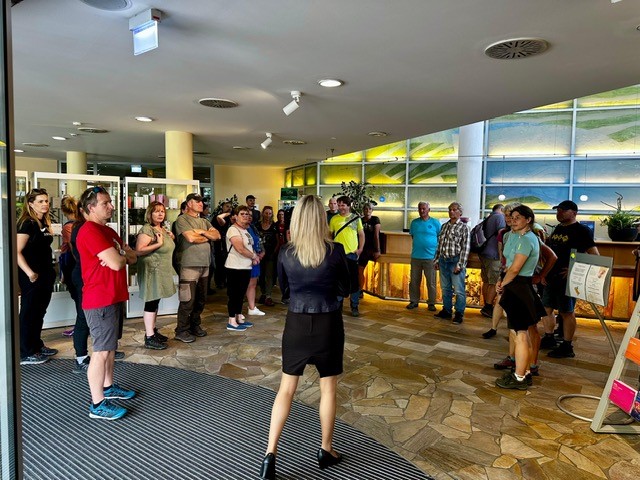 Menschen im Halbkreis m Gebäude